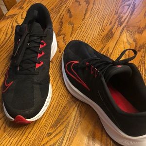 black and red Nike running shoes